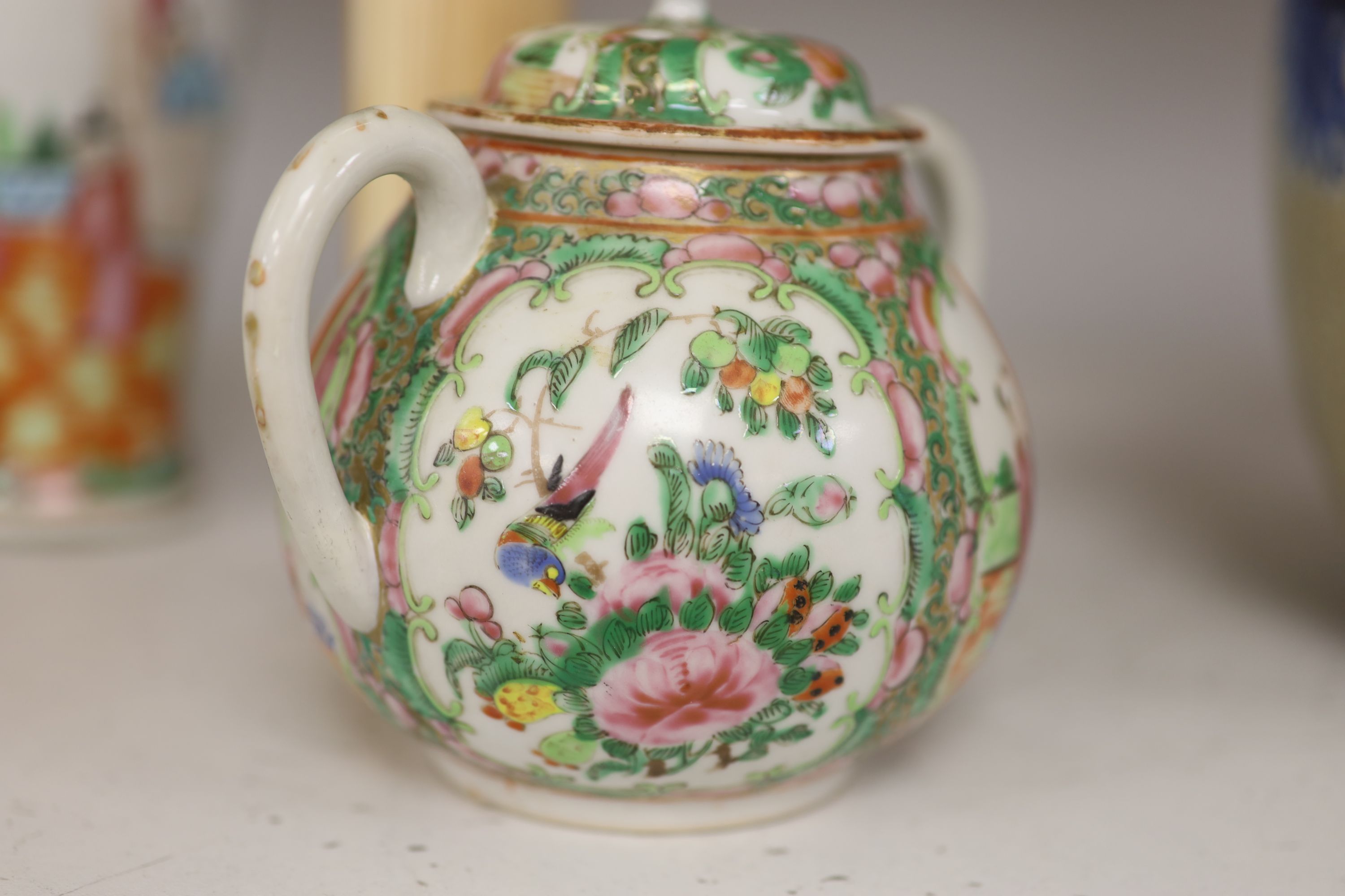 A Chinese famille rose box and cover, two vases, a sugar bowl and cover and a saucer, late 19th/early 20th century, tallest 19cm